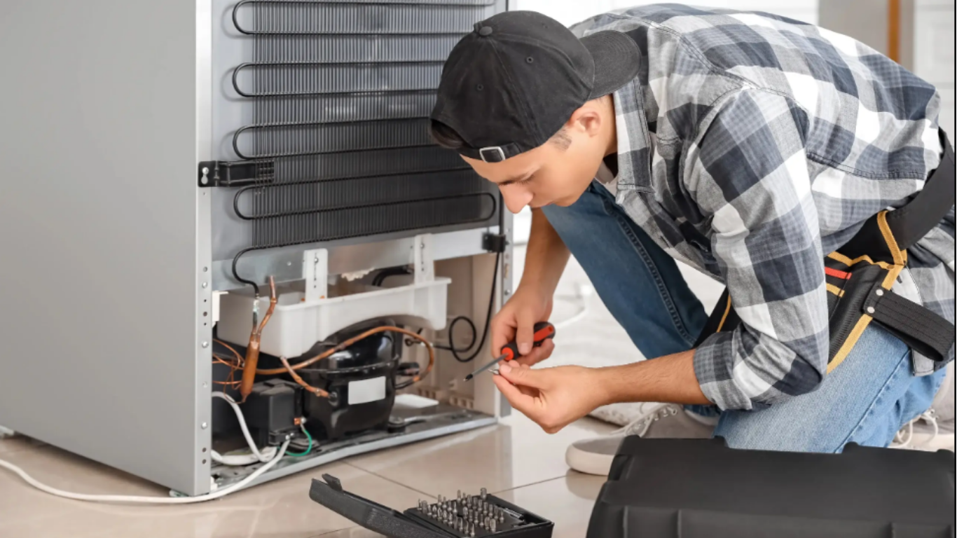 "Refrigerator repair technician fixing fridge cooling issue"